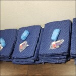 A row of blue blankets on top of a wooden table.